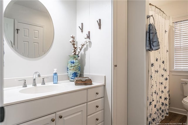 bathroom featuring a shower with shower curtain, vanity, toilet, and wood finished floors