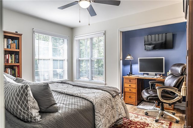 bedroom with a ceiling fan and wood finished floors