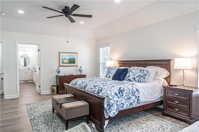 bedroom featuring baseboards, vaulted ceiling, wood finished floors, and recessed lighting