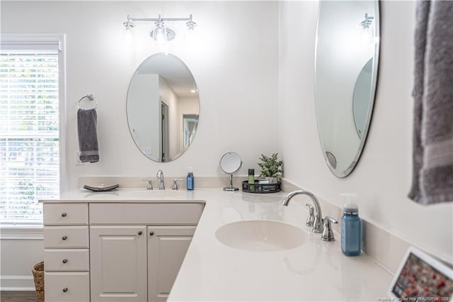 bathroom with a sink and double vanity