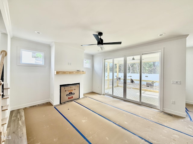 unfurnished living room featuring ornamental molding, french doors, baseboards, and a ceiling fan