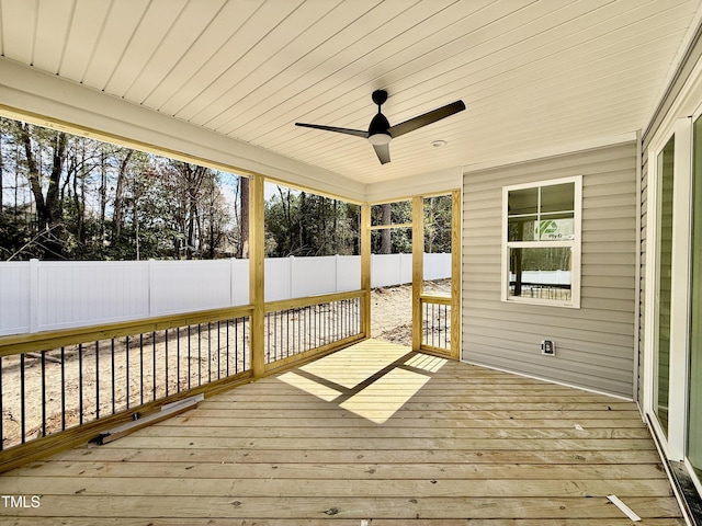 unfurnished sunroom featuring wood ceiling and a ceiling fan