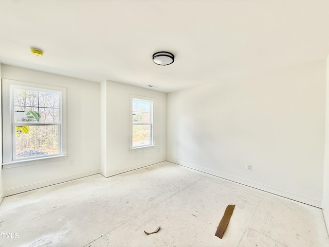 unfurnished room featuring baseboards