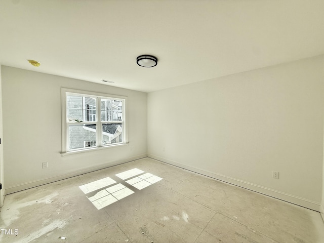 empty room with visible vents and baseboards