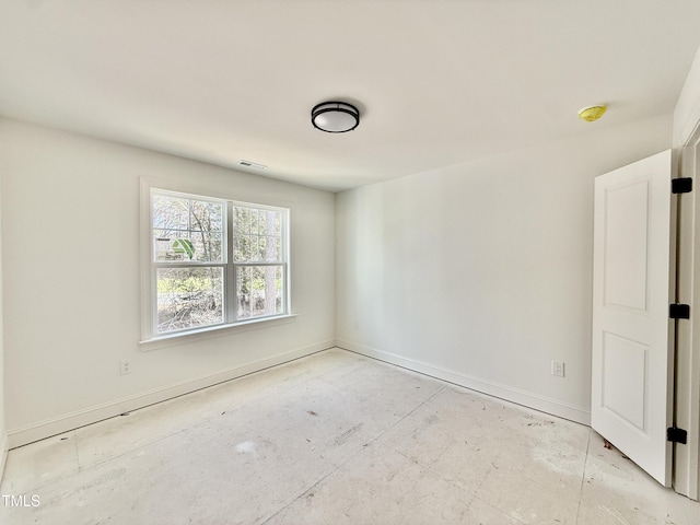 unfurnished room featuring visible vents and baseboards