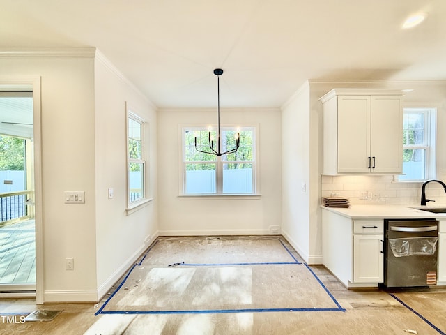kitchen featuring baseboards, ornamental molding, decorative backsplash, and dishwasher