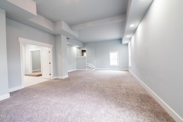 carpeted empty room featuring recessed lighting, stairs, and baseboards