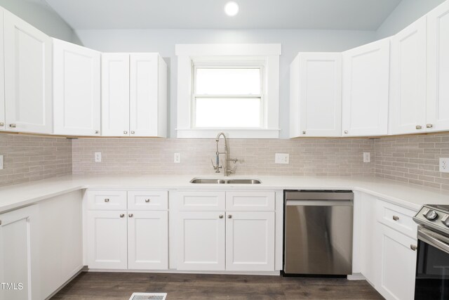 kitchen with tasteful backsplash, appliances with stainless steel finishes, light countertops, and a sink