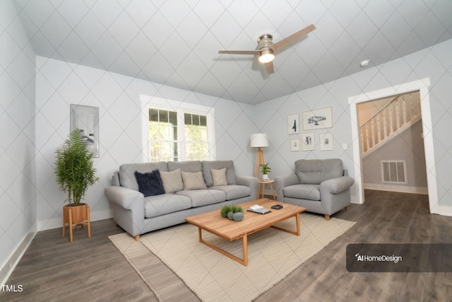 living area featuring dark wood-type flooring, stairway, baseboards, and visible vents