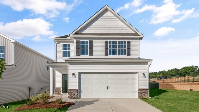 view of property with a garage and a front lawn