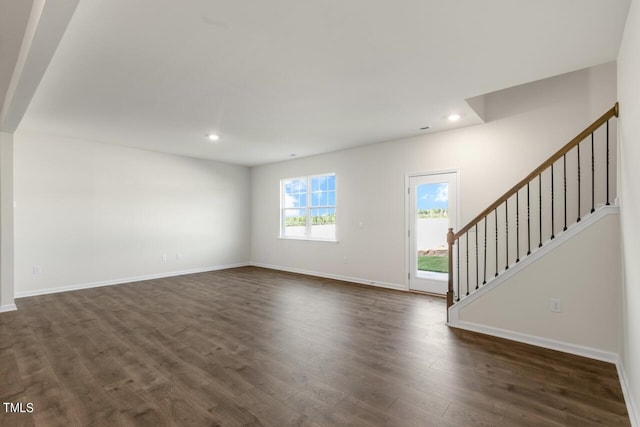 unfurnished living room with dark wood-type flooring