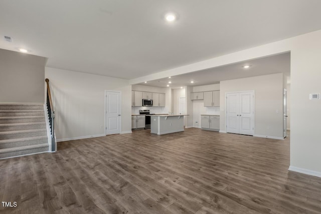 unfurnished living room featuring dark hardwood / wood-style flooring