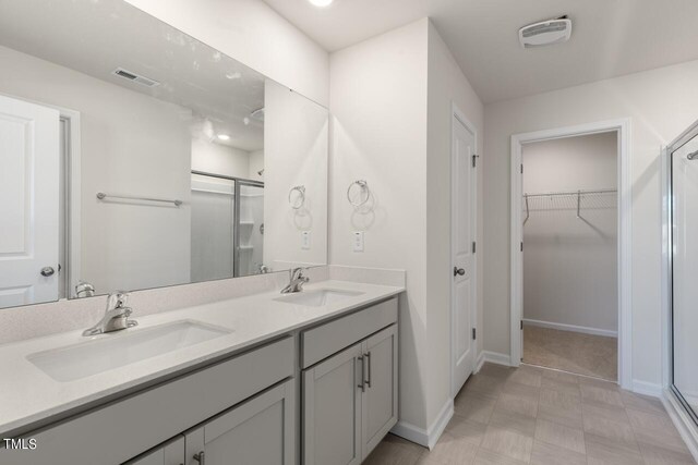 bathroom with vanity and a shower with shower door