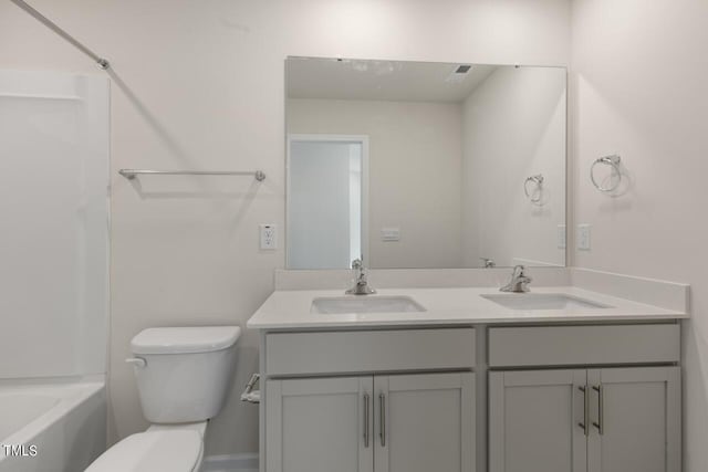 full bathroom with bathtub / shower combination, vanity, and toilet