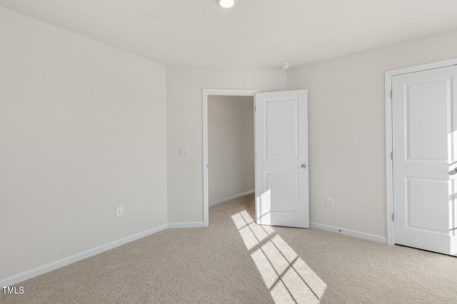 unfurnished room with light carpet