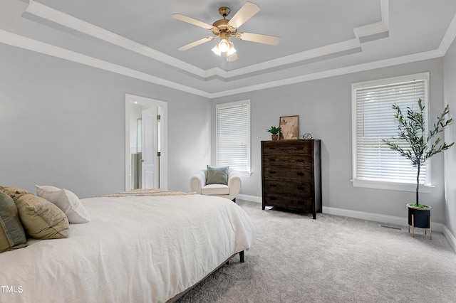 bedroom with ceiling fan, crown molding, a raised ceiling, and carpet floors