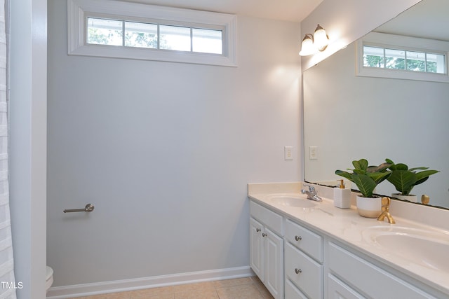 bathroom with a healthy amount of sunlight, vanity, and tile patterned floors