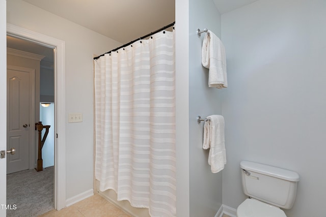 bathroom with tile patterned floors, toilet, ornamental molding, and shower / tub combo