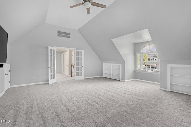 bonus room featuring ceiling fan, built in shelves, french doors, and carpet floors