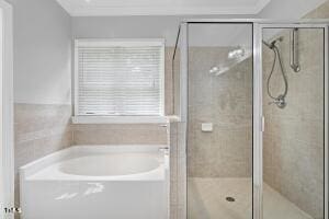 bathroom with shower with separate bathtub