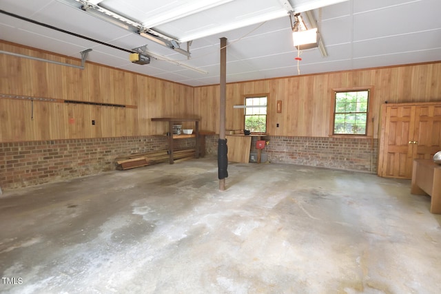 garage with a garage door opener and wood walls