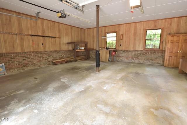 garage with wood walls and a garage door opener