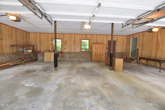 garage featuring a garage door opener and wooden walls