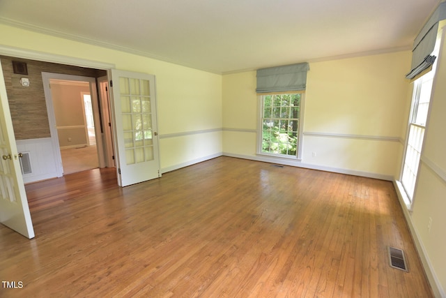 empty room featuring hardwood / wood-style flooring and crown molding