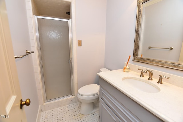 bathroom featuring vanity, toilet, and an enclosed shower