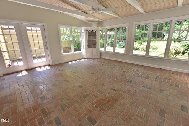 unfurnished sunroom featuring a wealth of natural light, ceiling fan, and wood ceiling