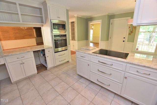 kitchen featuring appliances with stainless steel finishes, plenty of natural light, and white cabinetry