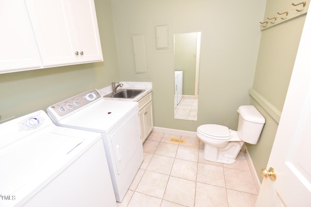 laundry area with washer and dryer, sink, and light tile patterned floors