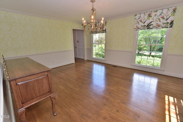 interior space with crown molding, a chandelier, and hardwood / wood-style flooring