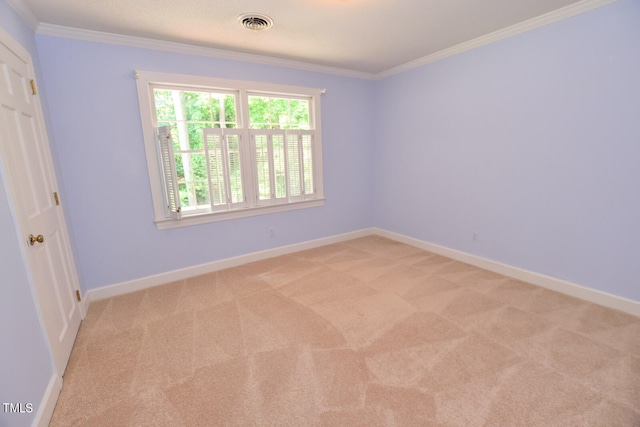 carpeted spare room featuring crown molding