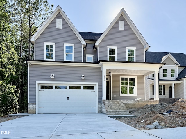2613 Silver Gate Ct, Wake Forest, NC 27587 - view of front of home featuring concrete driveway, an attached garage, and covered porch