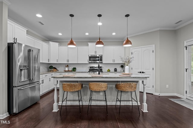 kitchen featuring pendant lighting, white cabinetry, a kitchen island with sink, stainless steel appliances, and light stone counters