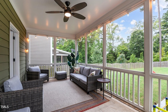 sunroom with a wealth of natural light and ceiling fan