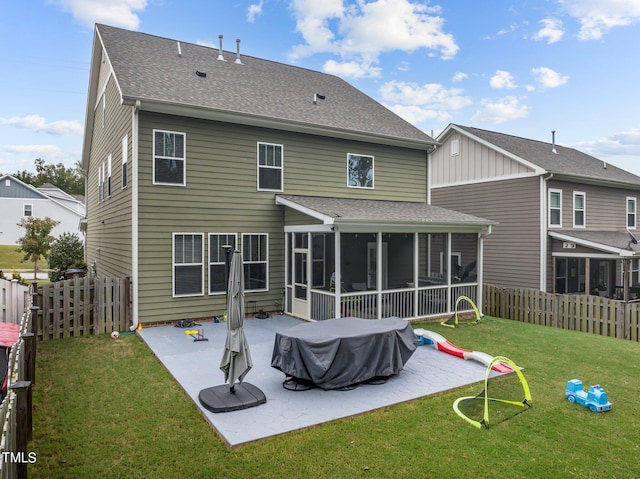 back of property featuring a patio, a sunroom, and a lawn