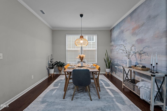 dining area featuring dark hardwood / wood-style flooring and ornamental molding