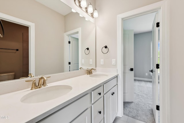 bathroom with vanity, toilet, and tile patterned floors