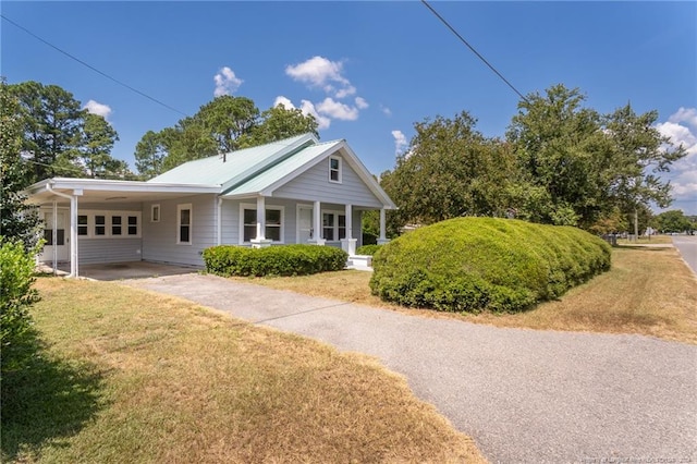 111 Sanford Rd, Laurinburg, NC 28352 - view of front of house with a porch, a front yard, an attached carport, and driveway