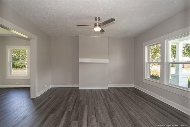 111 Sanford Rd, Laurinburg, NC 28352 - unfurnished room with dark wood finished floors, a ceiling fan, a healthy amount of sunlight, and a textured ceiling