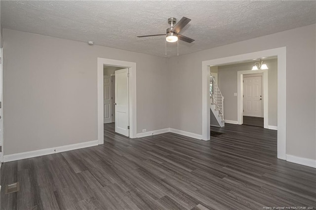 111 Sanford Rd, Laurinburg, NC 28352 - empty room featuring dark wood-style flooring, a textured ceiling, ceiling fan with notable chandelier, and baseboards