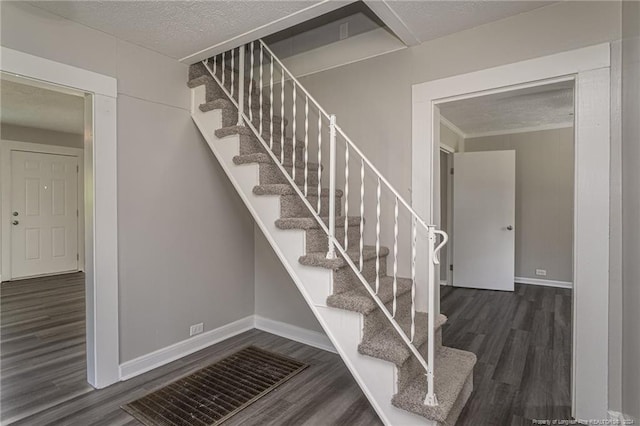 111 Sanford Rd, Laurinburg, NC 28352 - staircase featuring baseboards, a textured ceiling, and wood finished floors