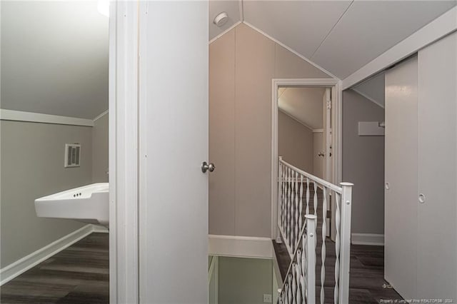 111 Sanford Rd, Laurinburg, NC 28352 - hall featuring an upstairs landing, wood finished floors, visible vents, baseboards, and lofted ceiling