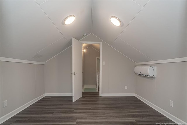 111 Sanford Rd, Laurinburg, NC 28352 - additional living space featuring vaulted ceiling, dark wood-style flooring, baseboards, and an AC wall unit