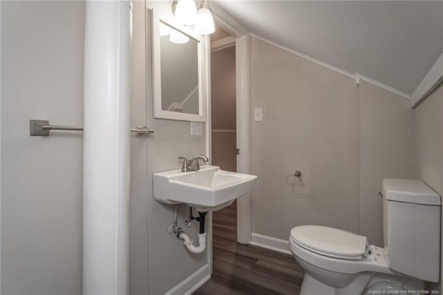 111 Sanford Rd, Laurinburg, NC 28352 - half bath featuring toilet, vaulted ceiling, wood finished floors, and baseboards