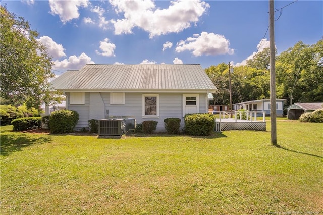 111 Sanford Rd, Laurinburg, NC 28352 - rear view of house featuring cooling unit, metal roof, and a lawn