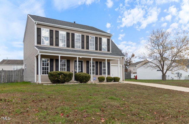 view of front of property with a porch, a garage, and a front lawn