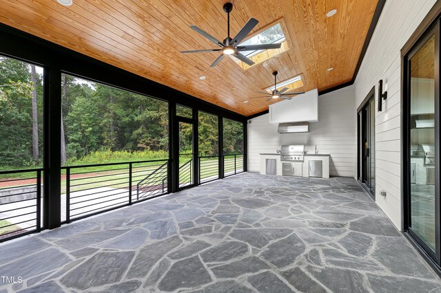 unfurnished sunroom with vaulted ceiling with skylight, wooden ceiling, and a healthy amount of sunlight